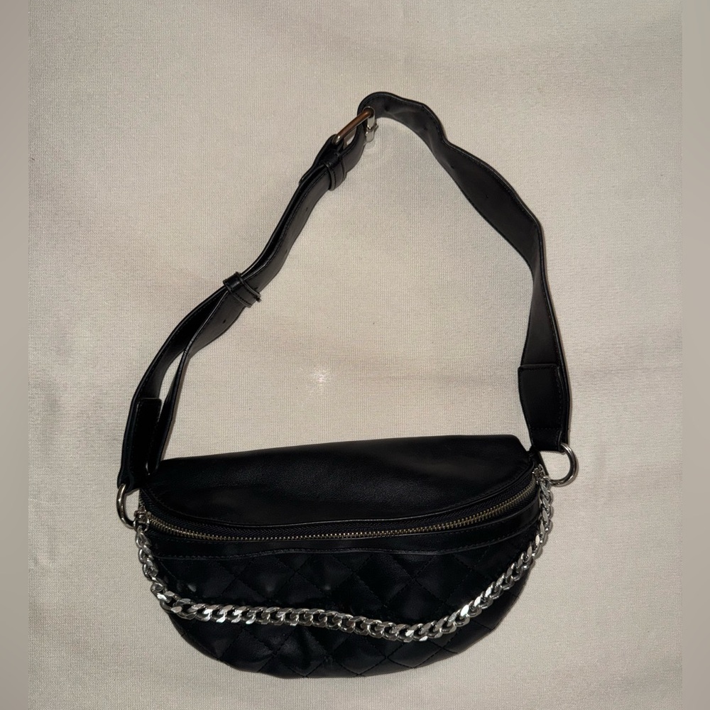 Black paneled shoulder bag, Thick trap with chain accents.